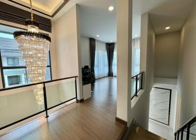 Elegant hallway with a chandelier and wooden flooring