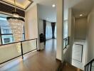 Elegant hallway with a chandelier and wooden flooring