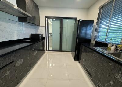 Modern kitchen with sleek black countertops and cabinets