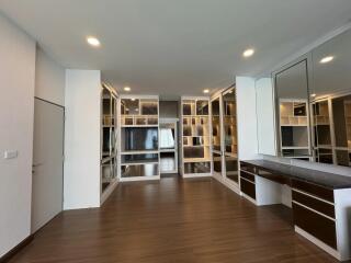 Modern living space with built-in shelves and large mirror