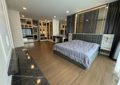 Spacious modern bedroom with stylish decor and ample natural light