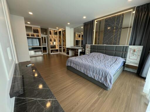 Spacious modern bedroom with stylish decor and ample natural light