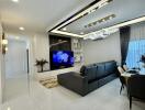 Modern living area with sectional sofa, TV, and dining space