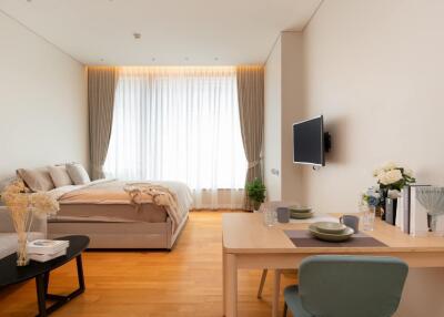 Cozy and modern bedroom with a combined living area and natural light