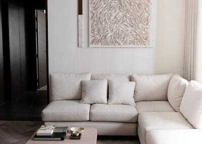 Modern living room with beige sectional sofa and wall art