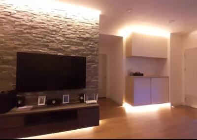 Modern living room with stone accent wall and ambient lighting