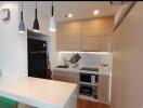 Modern kitchen with black refrigerator and white countertops