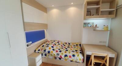 Cozy bedroom with study desk and built-in shelves