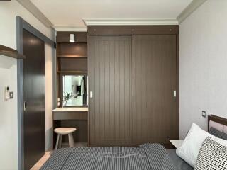 Modern bedroom with built-in wardrobe and small dressing table