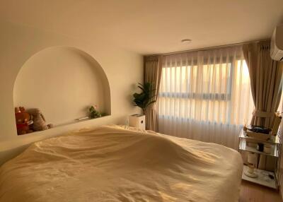 Cozy bedroom with a large bed and natural lighting