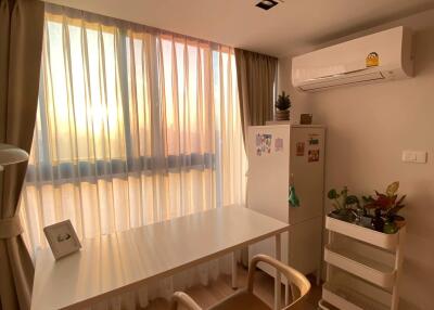 Small dining area with table, chair, and a window