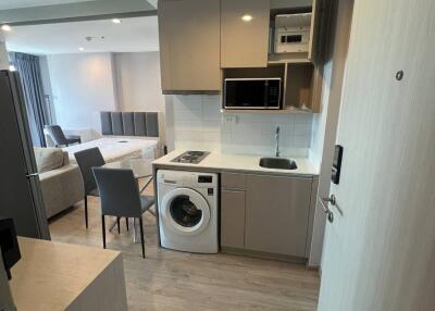 Modern kitchen with integrated appliances and view of living area