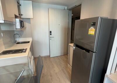 Modern kitchen area with appliances and dining space