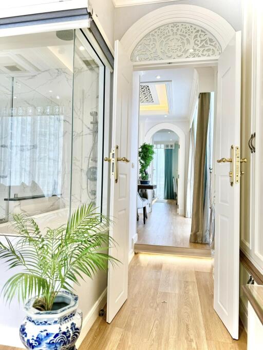 Elegant hallway with glass partition and decorative details