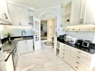 Modern kitchen with white cabinetry and appliances