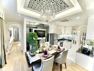 Elegant dining and kitchen area with chandelier and modern decor