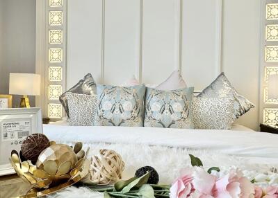 Well-decorated bedroom with elegant bedding and floral decor