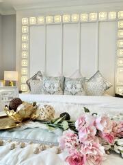 Well-decorated bedroom with elegant bedding and floral decor