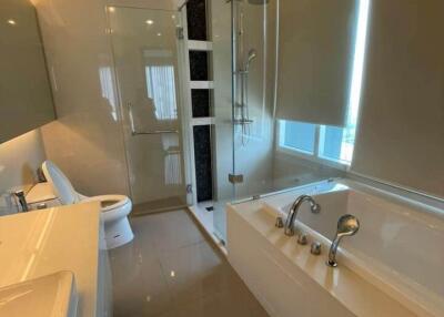 Modern bathroom with a bathtub and glass-enclosed shower