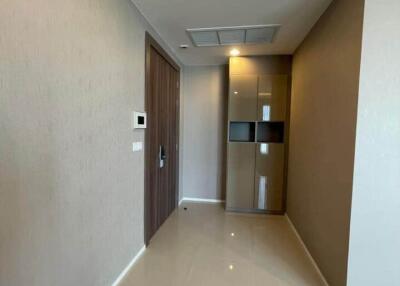 Modern hallway with glossy tiled floor and wooden door