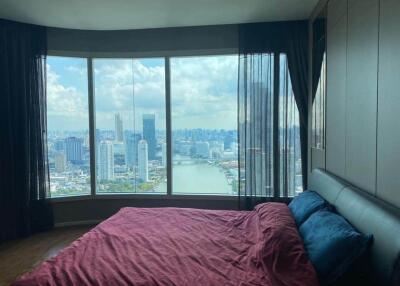 Bedroom with a large window and cityscape view