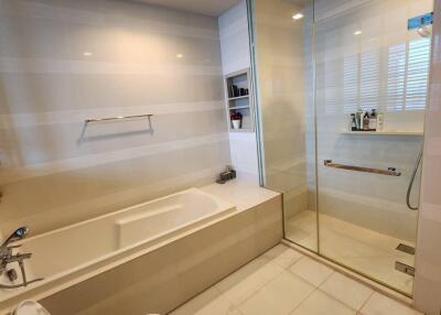 Modern bathroom with bathtub and glass-enclosed shower