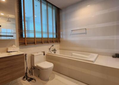 Modern bathroom with bathtub and wooden blinds