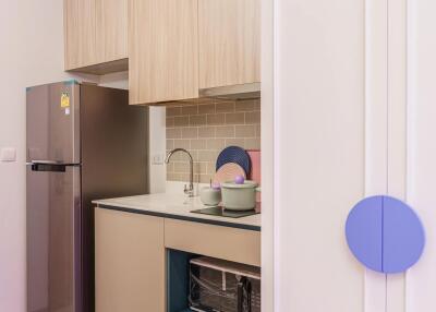 Modern kitchen with light wood cabinets and stainless steel appliances