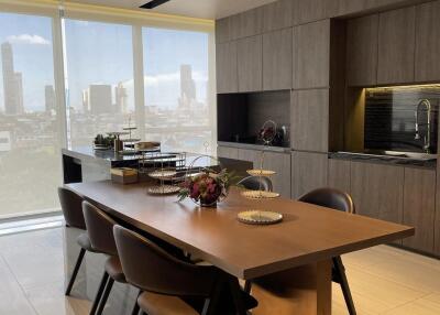 Modern kitchen with dining area and city view