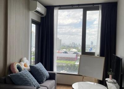 Modern living room with large windows and city view