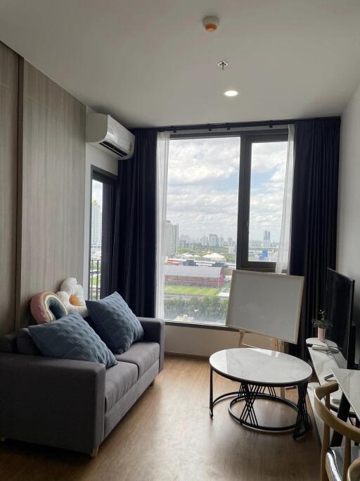 Modern living room with large windows and city view