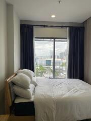 Modern bedroom with large window and city view