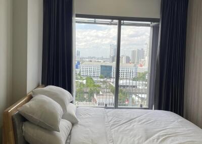 Bright bedroom with large window and city view