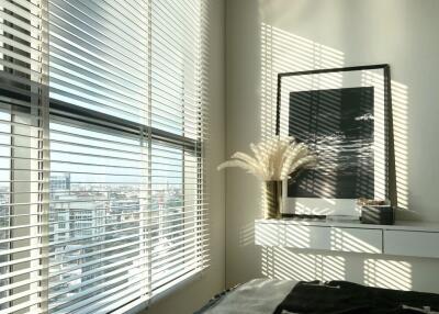 Modern bedroom with large windows and blinds