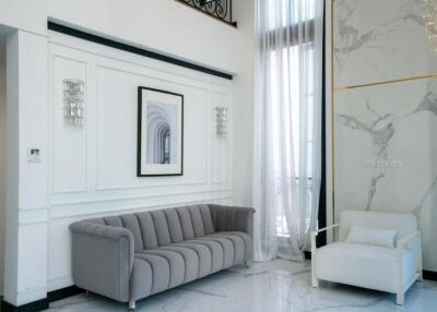 Modern living room with grey sofa and white armchair