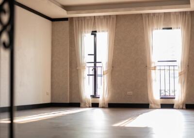 Spacious empty living room with large windows and natural light