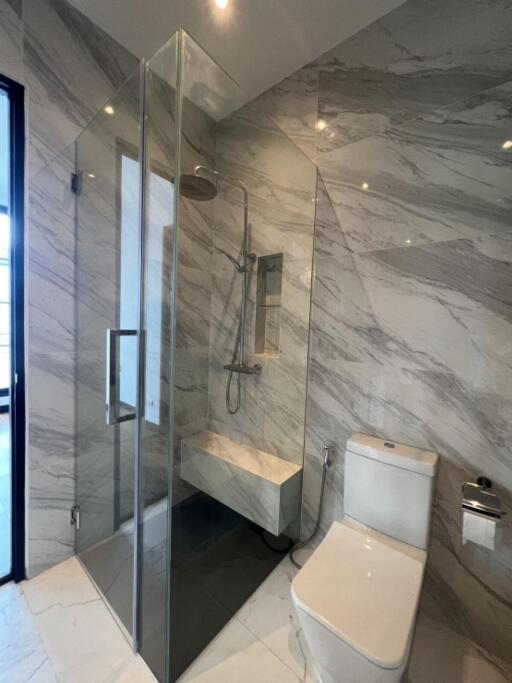 Modern bathroom with glass shower and white toilet