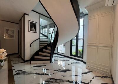 Elegant entrance with a spiral staircase