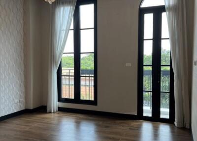 Spacious living room with large windows and chandelier