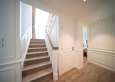 Elegant hallway with staircase and closed doors