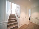 Elegant hallway with staircase and closed doors