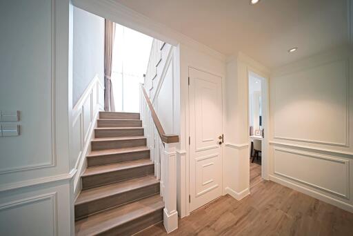 Elegant hallway with staircase and closed doors