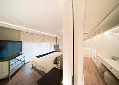 Bedroom with modern furnishings and a walk-in closet