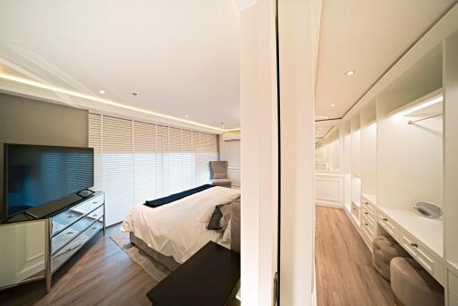 Bedroom with modern furnishings and a walk-in closet