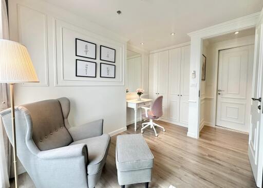 Bright bedroom with cozy armchair and study area