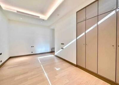 Spacious bedroom with built-in wardrobes and ceiling lighting