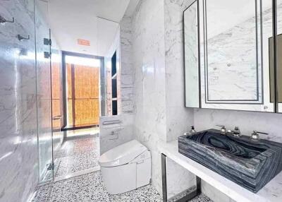 Modern bathroom with marble walls and designer sink