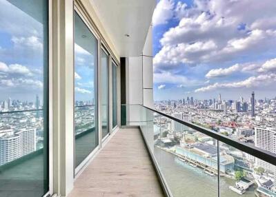 High rise apartment balcony with glass railing and city view