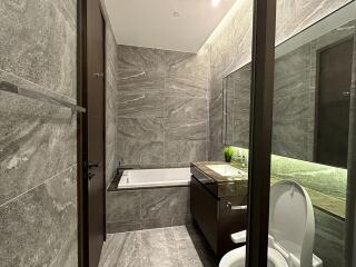 Modern gray tile bathroom with bathtub and sink