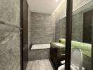 Modern gray tile bathroom with bathtub and sink